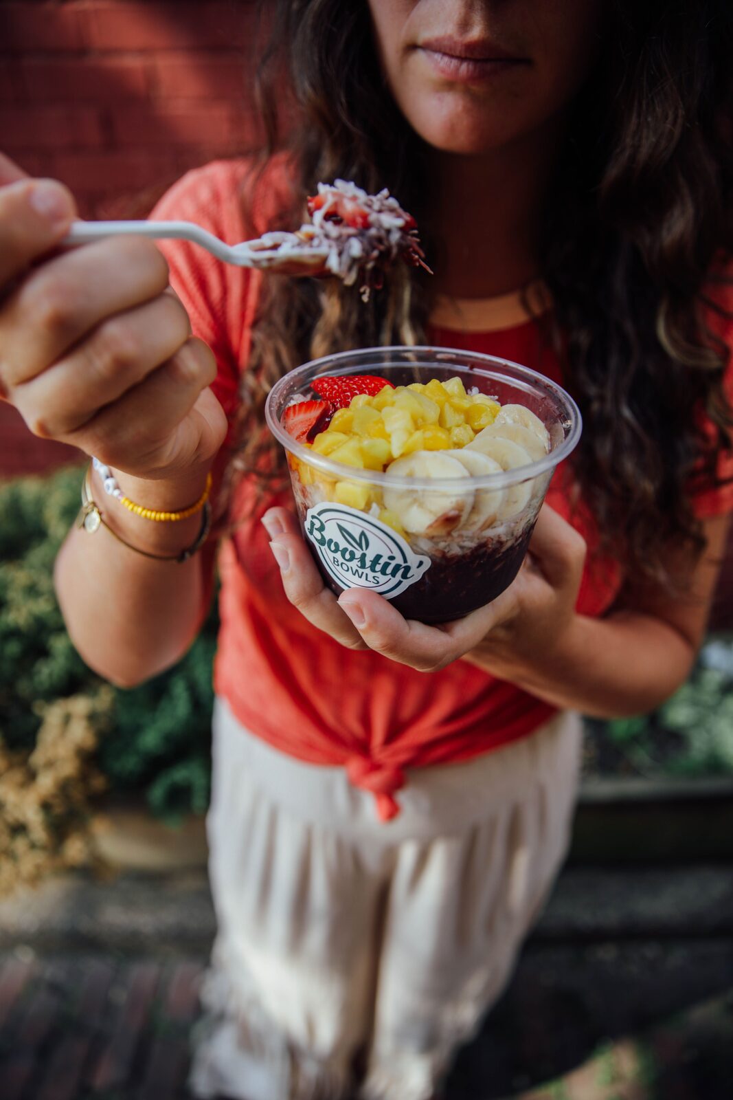 A spoonful of açaí and granola lifted from a bowl